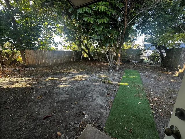 a view of a yard with a tree