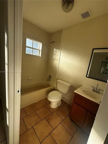a bathroom with a toilet a sink and shower
