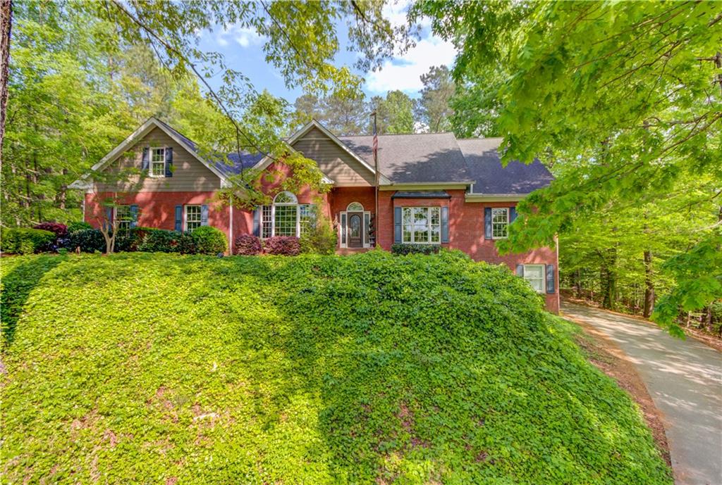 3305 Wildwood Road Suwanee, GA 30024 - Photo 1 of 1 a front view of a house with a yard