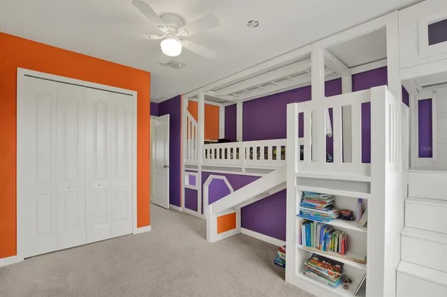 a bedroom with a large bed and potted plant