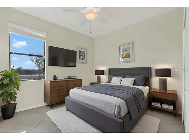 a bedroom with a bed and a flat screen tv