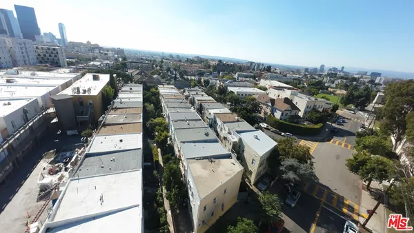 an aerial view of a residential houses with city view