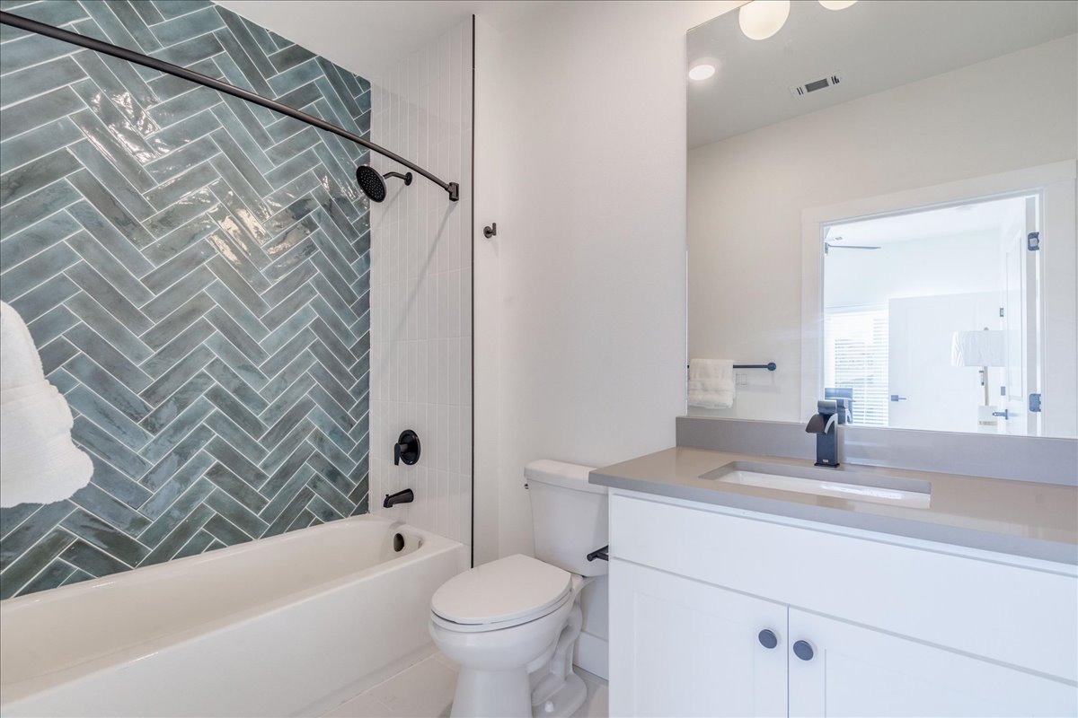 3000 Duval Street, Unit 302 Austin, TX 78705 - Photo 10 of 28 a bathroom with a bathtub shower sink vanity and toilet