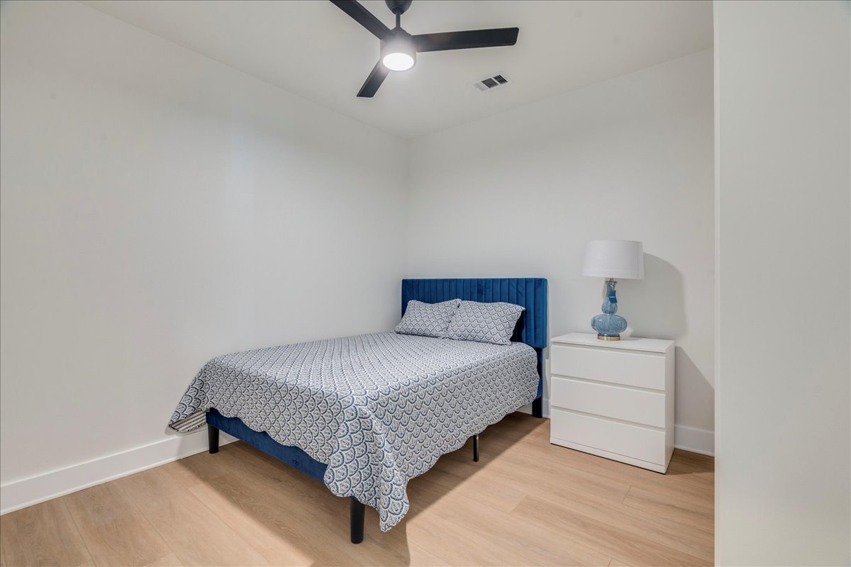 3000 Duval Street, Unit 302 Austin, TX 78705 - Photo 17 of 28 a bedroom with a bed and a dresser