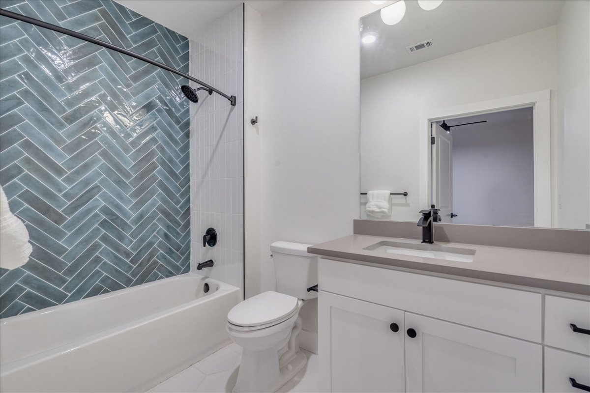 3000 Duval Street, Unit 302 Austin, TX 78705 - Photo 19 of 28 a bathroom with a sink a toilet and shower
