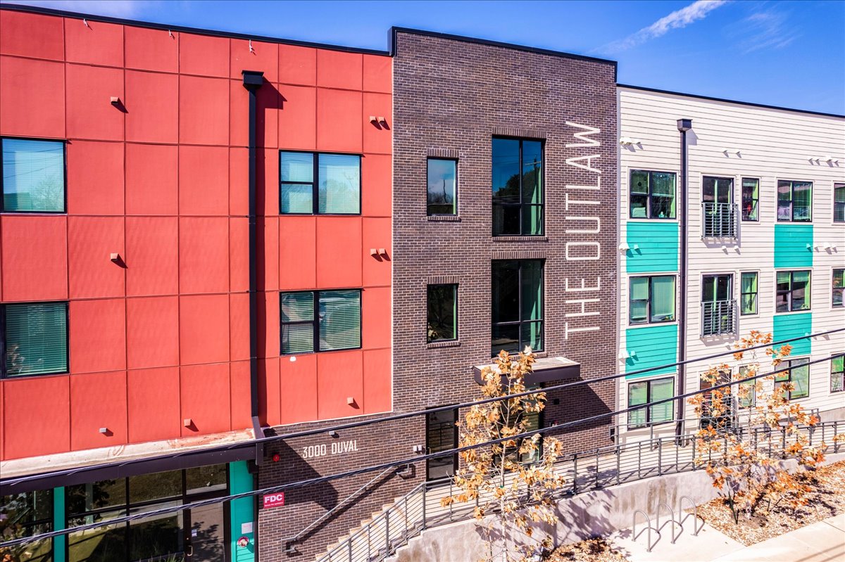 3000 Duval Street, Unit 302 Austin, TX 78705 - Photo 2 of 28 front view of a brick building with a bench in front of building