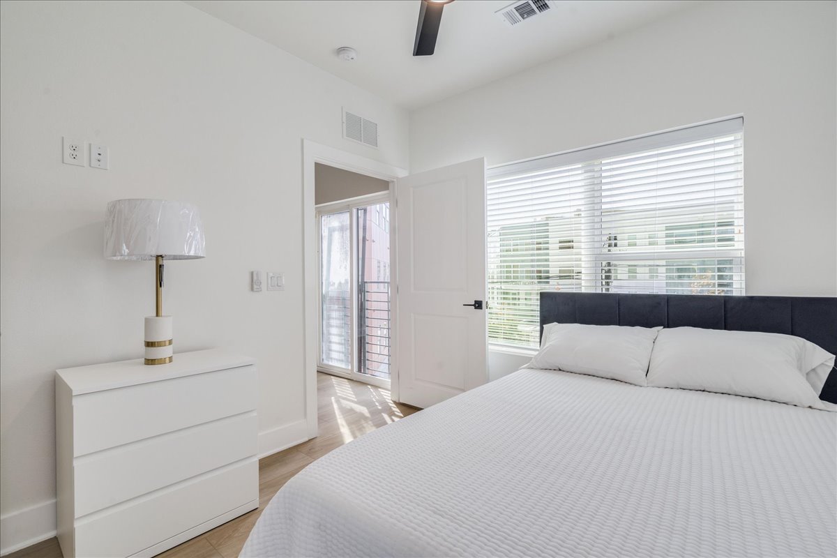 3000 Duval Street, Unit 302 Austin, TX 78705 - Photo 3 of 28 a bedroom with a bed and a night stand