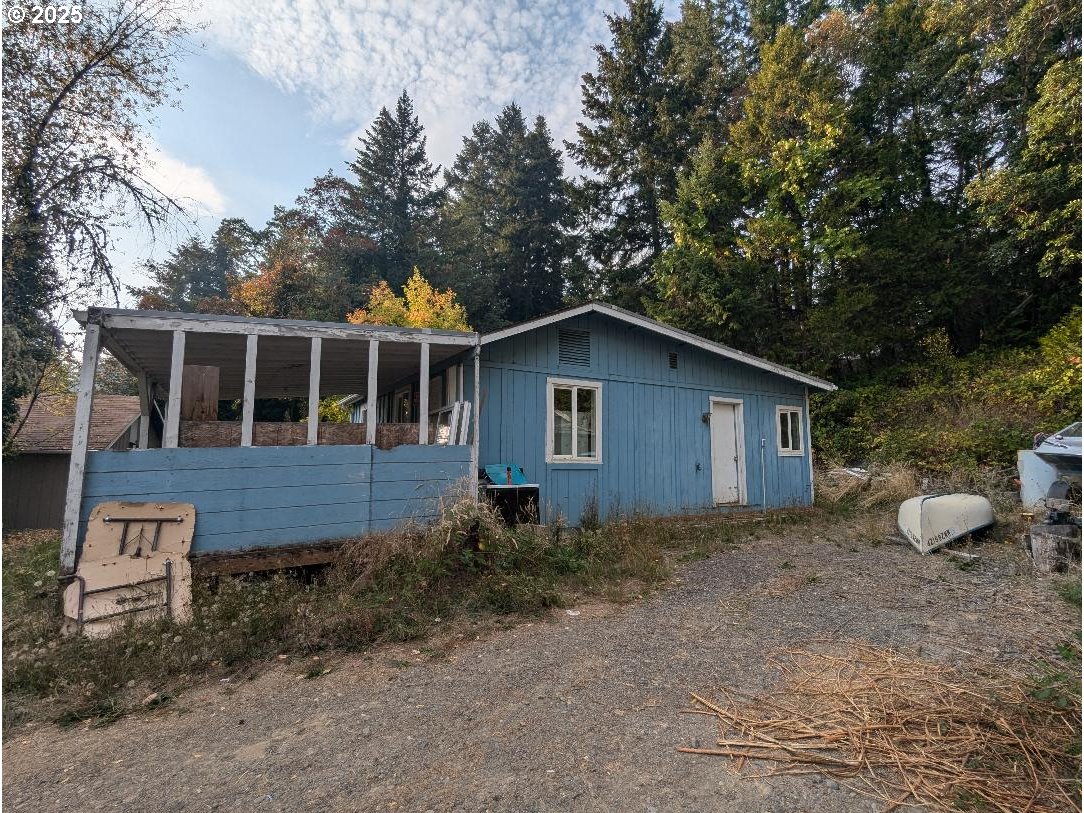 48391 Roberts Road Oakridge, OR 97463 - Photo 4 of 20 a view of house with backyard space and garden