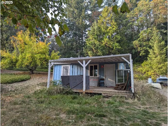 a backyard of a house with table and chairs