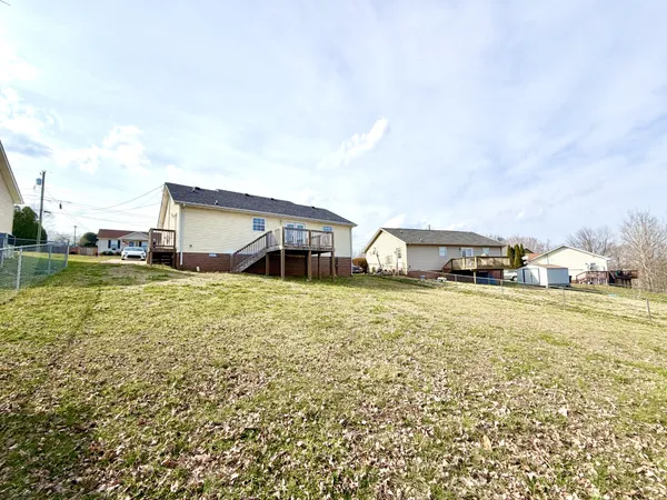 a view of a house with backyard and porch
