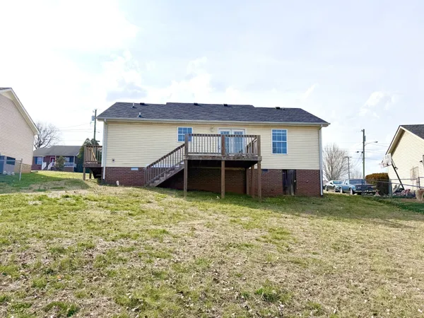 a view of a house with yard and sitting area