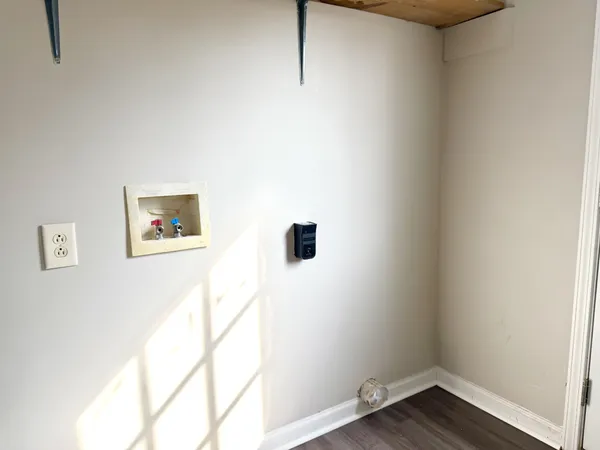 a view of a hallway with wooden floor and closet