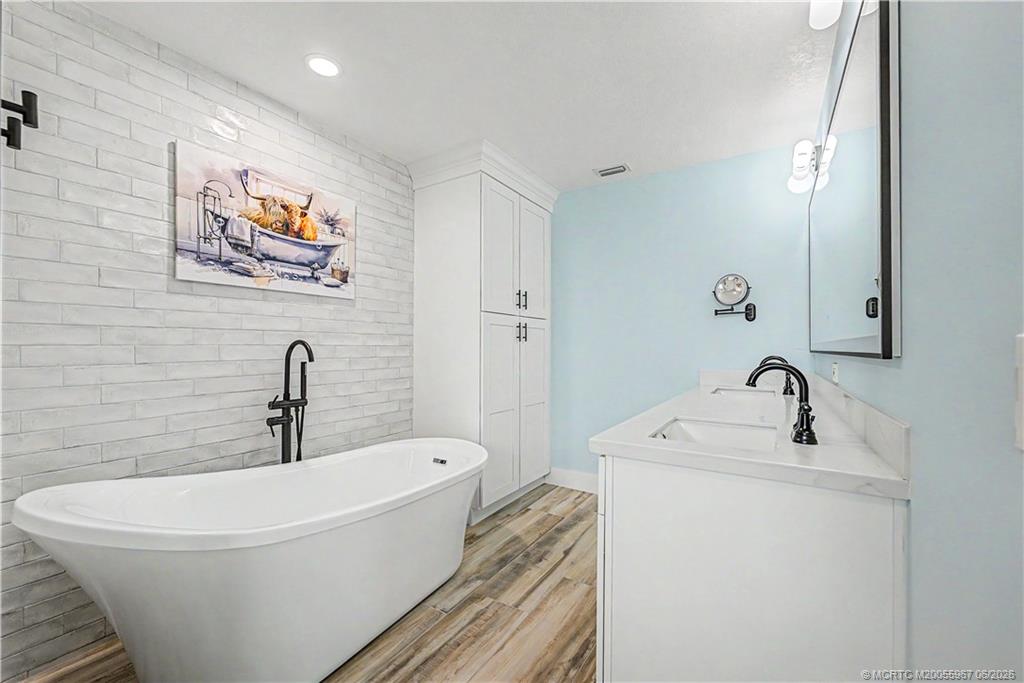 8200 Southwest Springhaven Avenue Indiantown, FL 34956 - Photo 25 of 35 a white bath tub sitting next to a white sink