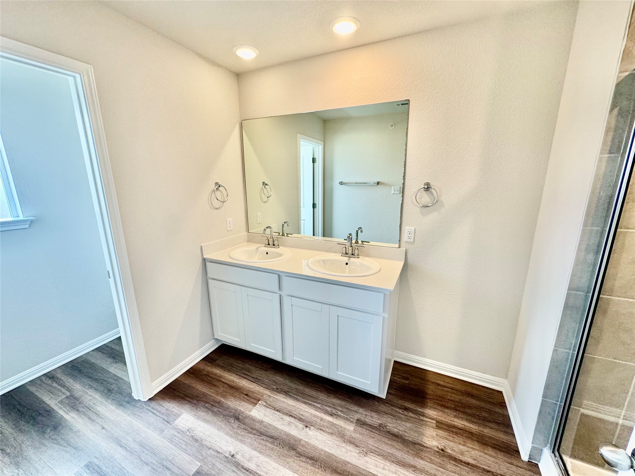 165 Calcite Road, Unit 3 Kyle, TX 78640 - Photo 4 of 17 a bathroom with a sink a mirror and a vanity