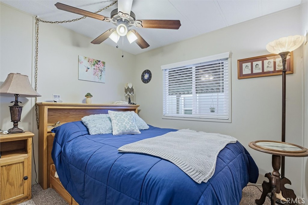 500 Atascadero Road, Unit D8 Morro Bay, CA 93442 - Photo 17 of 26 a bedroom with a bed and a chandelier