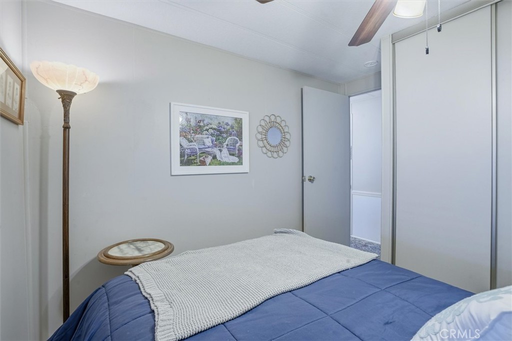 500 Atascadero Road, Unit D8 Morro Bay, CA 93442 - Photo 18 of 26 a bedroom with a bed and a painting on the wall