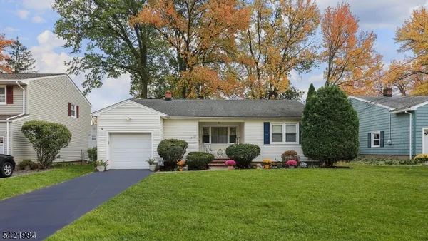 a front view of house with yard and green space