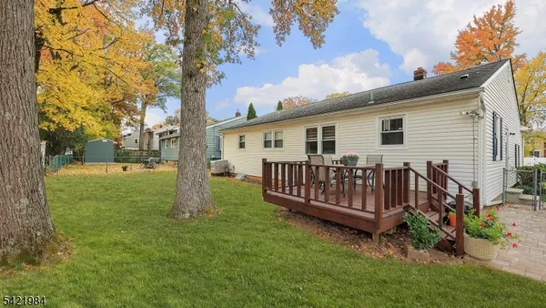 a view of a house with a yard and deck