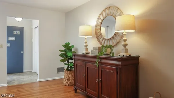 a view of a mirror light fixtures and wooden floor