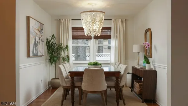a view of a dining room with furniture and chandelier