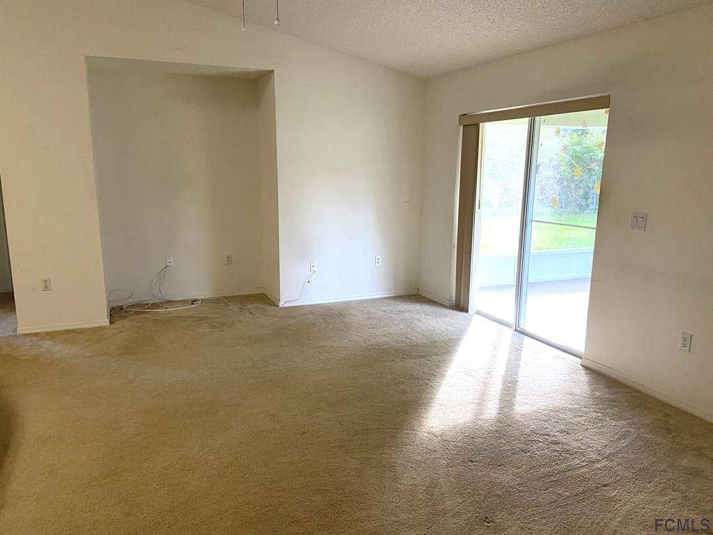62 Rae Drive Palm Coast, FL 32164 - Photo 7 of 24 Family Room to Screened in Patio