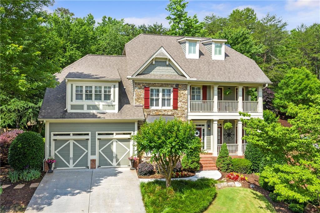 a aerial view of a house with a yard and potted plants