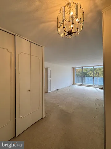 a view of a chandelier fan in hallway