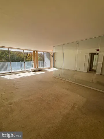 a view of empty room with floor to ceiling window