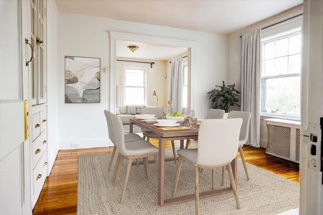 a view of a dining room with furniture and wooden floor