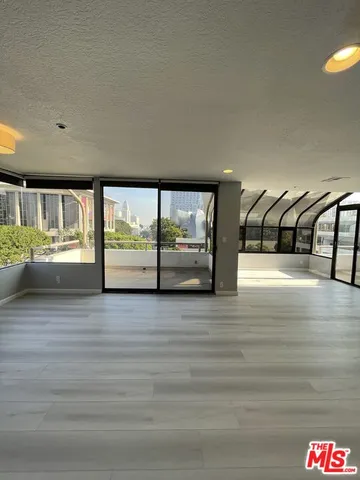 a view of an empty room with glass door