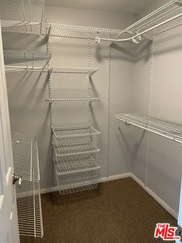 a room with a toilet sink and mirror