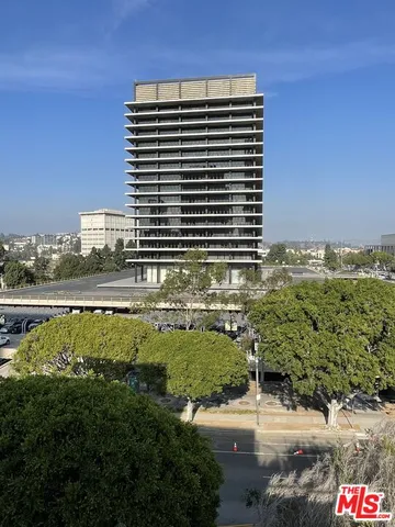 a front view of a building with outdoor seating