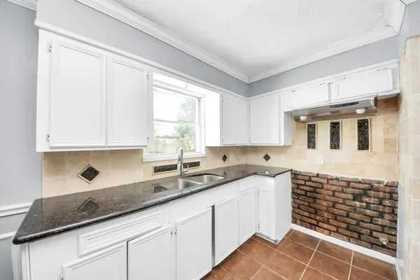 a kitchen with a sink and cabinets