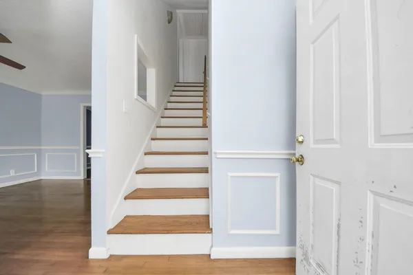 a view of an entryway with wooden floor