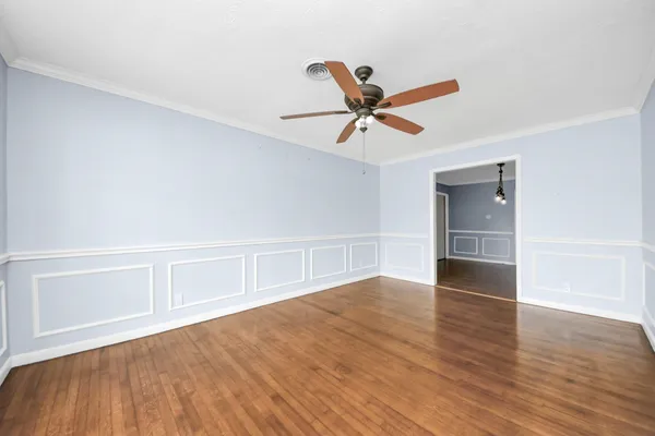 a view of an empty room with wooden floor