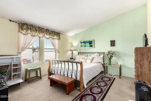 a bed room with a bed and a chair