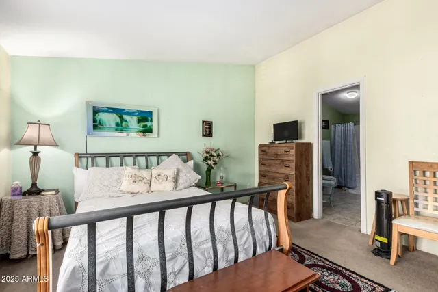 a bedroom with furniture and wooden floor