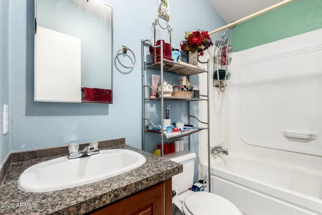 a bathroom with a sink a toilet and tub
