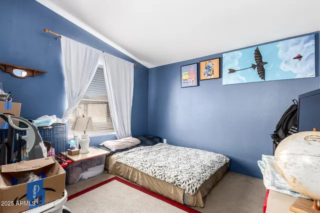 a bedroom with a bed and a window