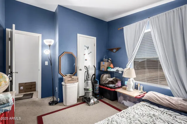 a bedroom with furniture and a mirror