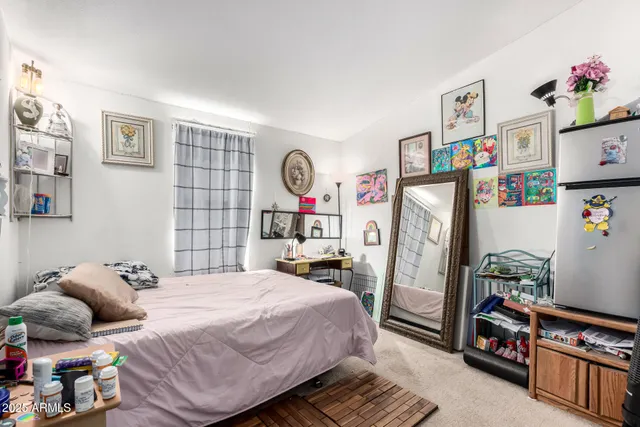 a bedroom with a bed and a window