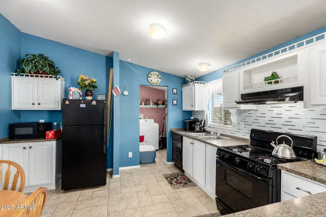 a kitchen with a sink stainless steel appliances and cabinets