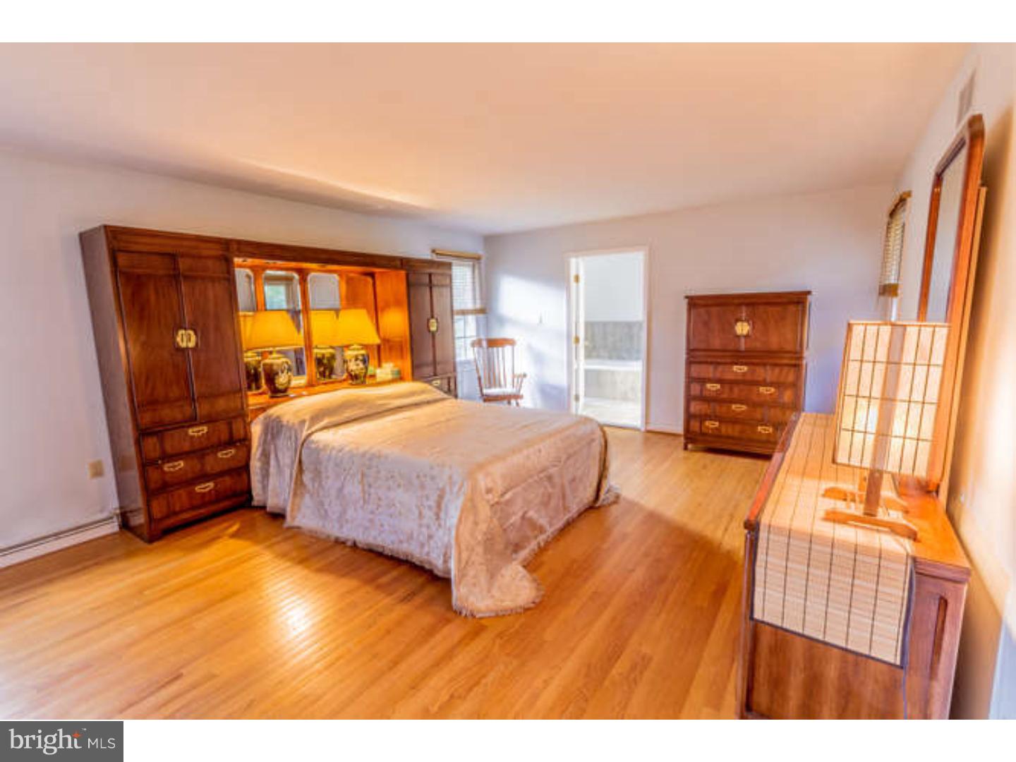 725 Burnley Road Wilmington, DE 19803 - Photo 15 of 23 a bedroom with a bed and wooden floor