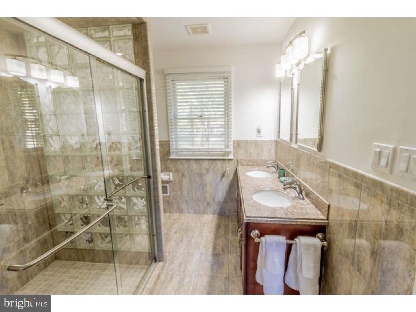 725 Burnley Road Wilmington, DE 19803 - Photo 17 of 23 a bathroom with a sink a mirror and a shower