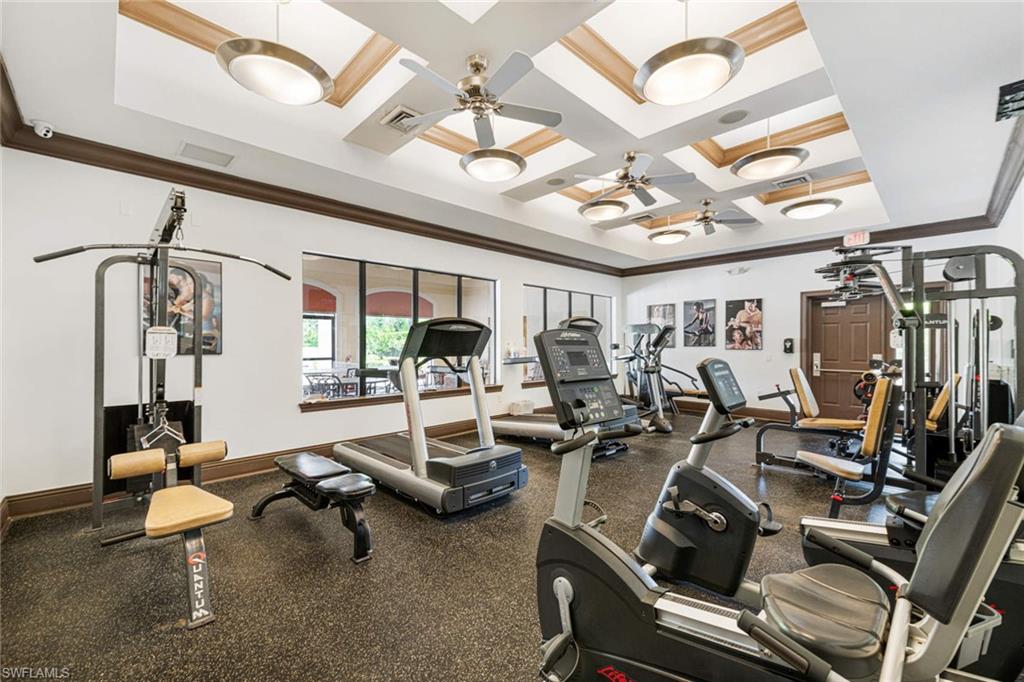 12980 Positano Circle, Unit 308 Naples, FL 34105 - Photo 21 of 22 a room with lots of chairs and mirrors