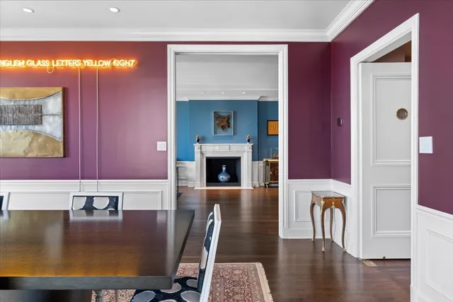 a view of a livingroom with furniture a fireplace and wooden floor