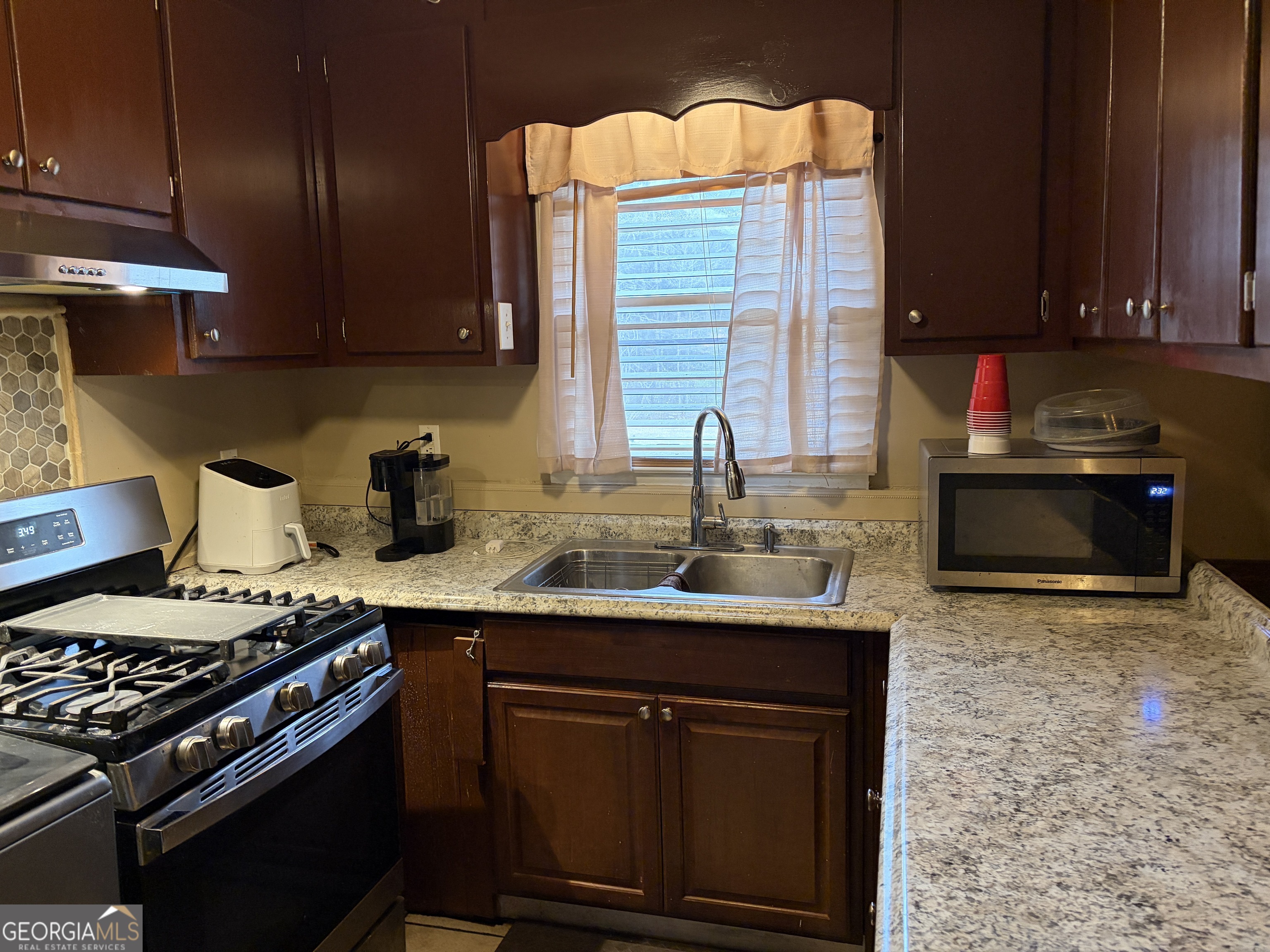 1216 North Bellview Road Aragon, GA 30104 - Photo 7 of 19 a kitchen with stainless steel appliances granite countertop a stove a sink and a microwave