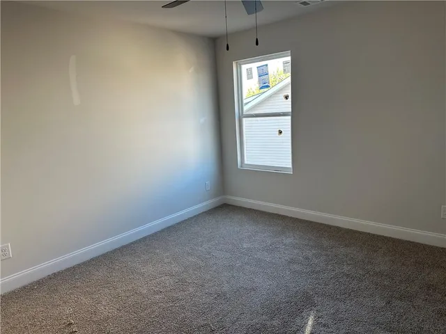 an empty room with a window and a mirror