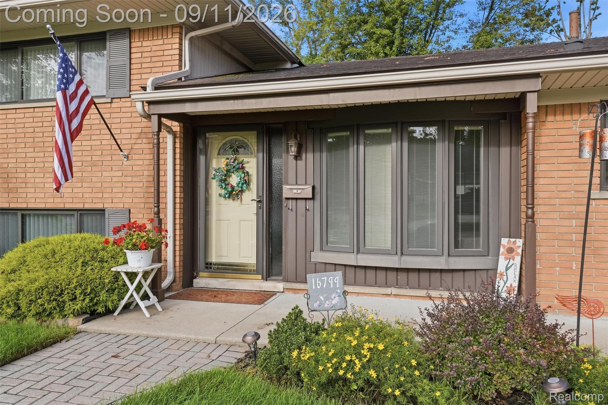 16799 Farmington Road Livonia, MI 48154 - Photo 5 of 71 Brick exterior with an arched entry door, bay window, and covered porch