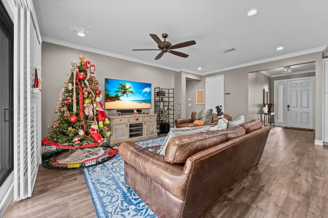 a kitchen with stainless steel appliances granite countertop a stove top oven a refrigerator a sink and chairs